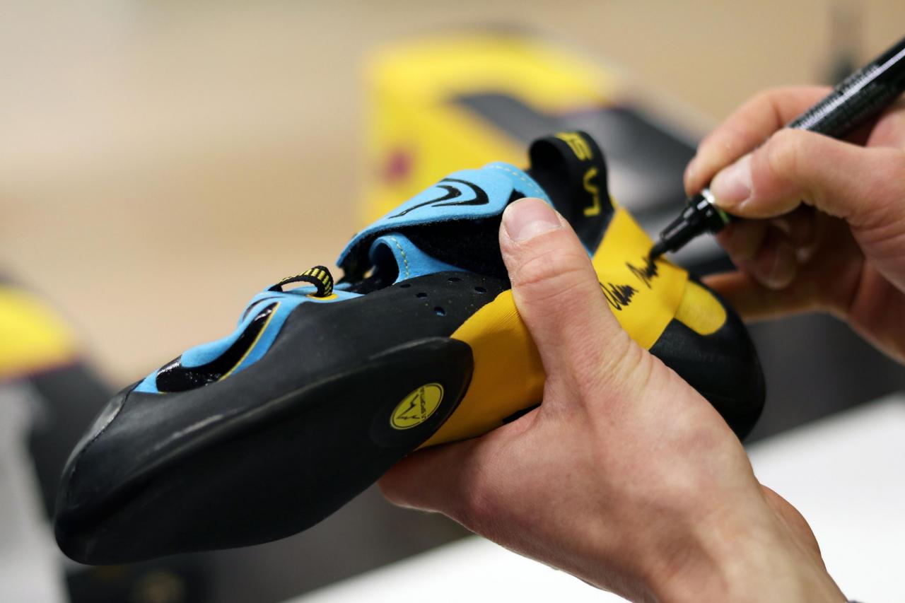 Adam signs climbing shoes at HQ La Sportiva